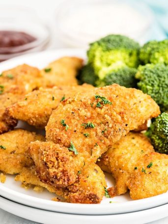 chicken tenders on a plate with broccoli