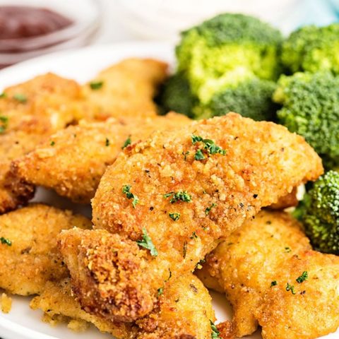 chicken tenders on a plate with broccoli