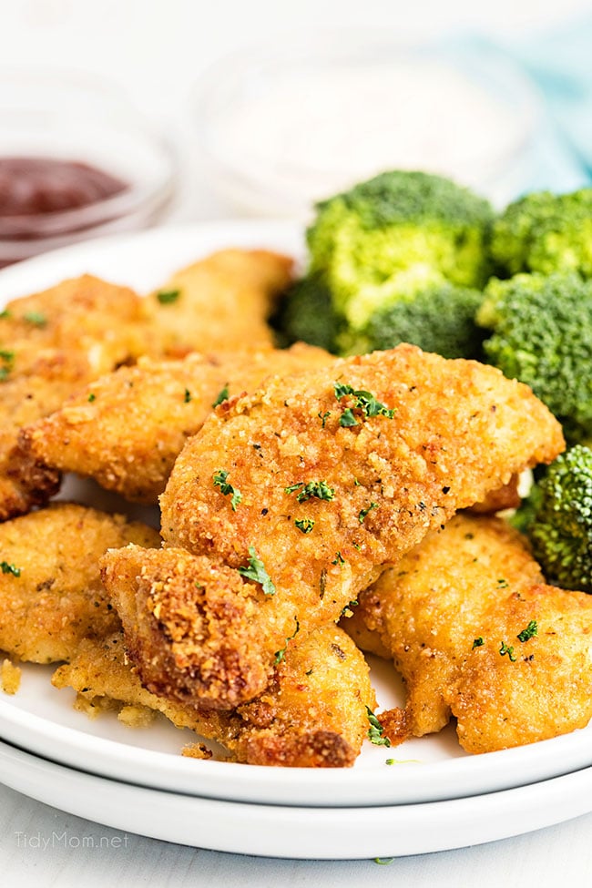 chicken tenders on a plate with broccoli