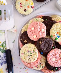chocolate, vanilla and strawberry cookies stacked on plate