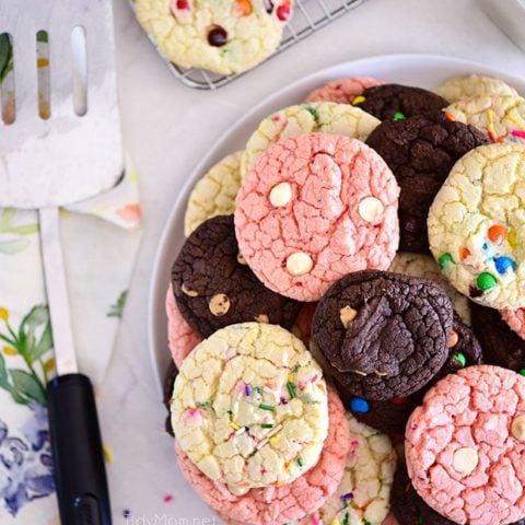 chocolate, vanilla and strawberry cookies stacked on plate