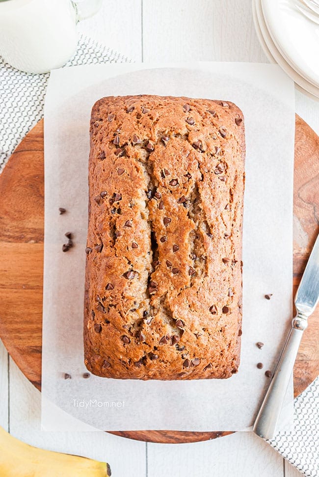 a whole loaf of banana bread on a round cutting board