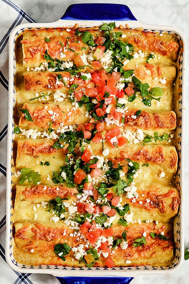 pan of chicken enchiladas with lots of toppings