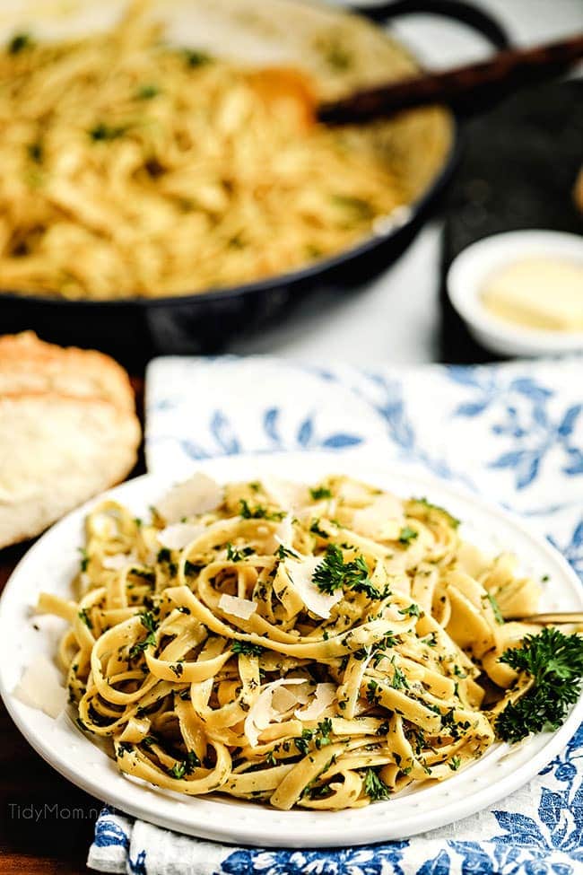 fettuccine alfredo on a plate with blue and white napkin