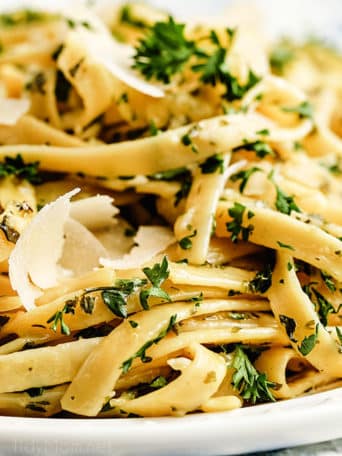 close up of creamy fettuccine alfredo with shaved Parmesan cheese