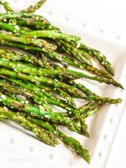 white plate with parmesan roasted asparagus