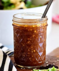 Canning jar with Honey Sesame Asian Salad Dressing and a spoon