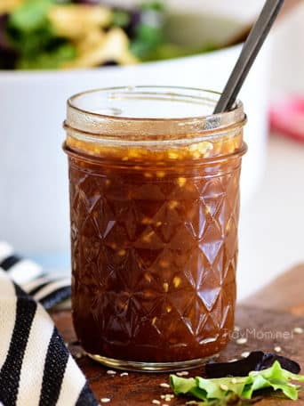 Canning jar with Honey Sesame Asian Salad Dressing and a spoon