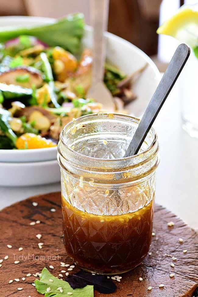 Honey Sesame salad dressing in a jar new to a bowl of salad