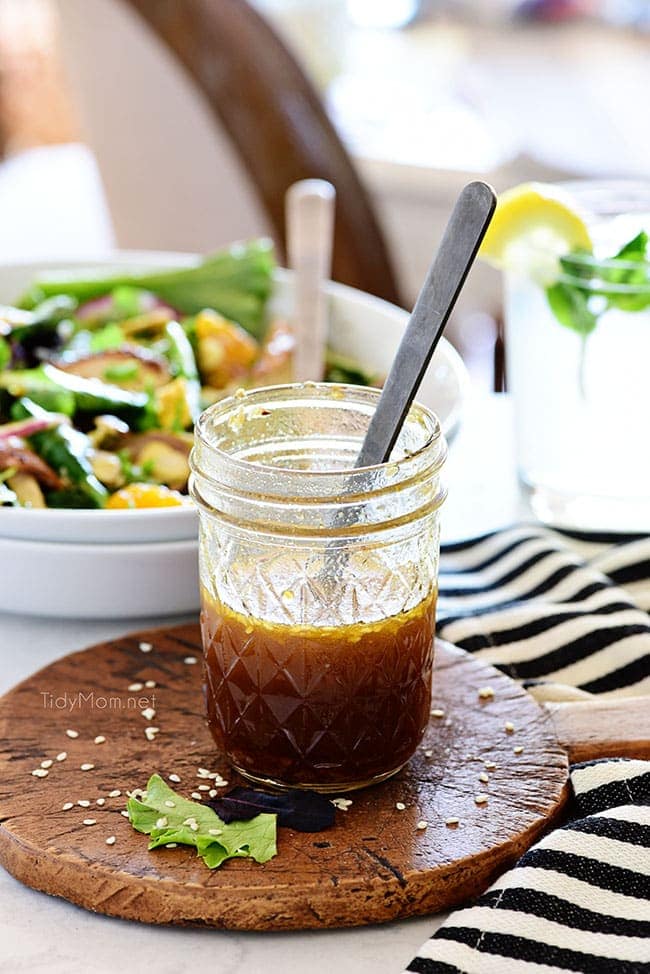 Jar of Sesame Vinaigrette and a bowl of salad