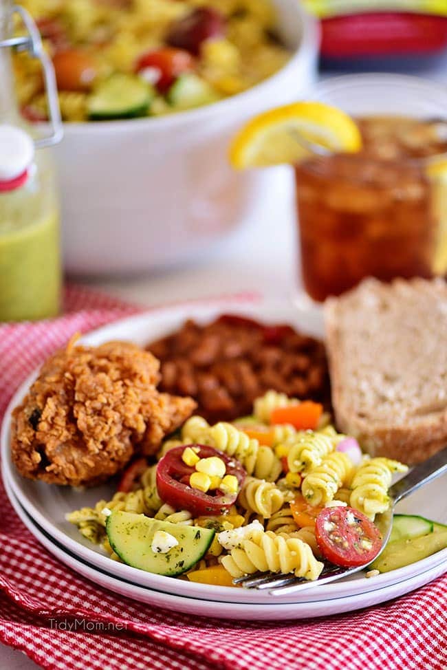 Summer pasta salad on a plate with fried chicken