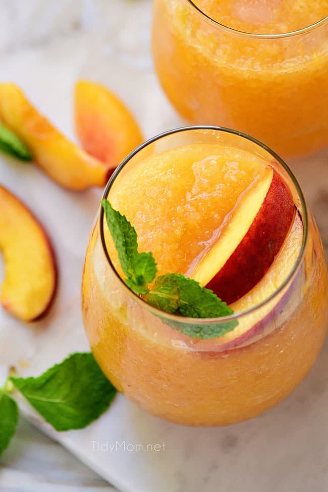 frozen peach cocktail with a fresh peach slice