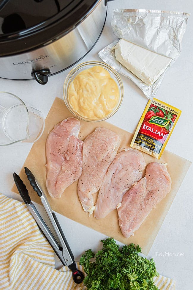 raw chicken breast with other ingredients around it