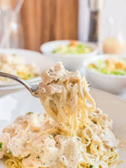 creamy chicken and pasta on a fork