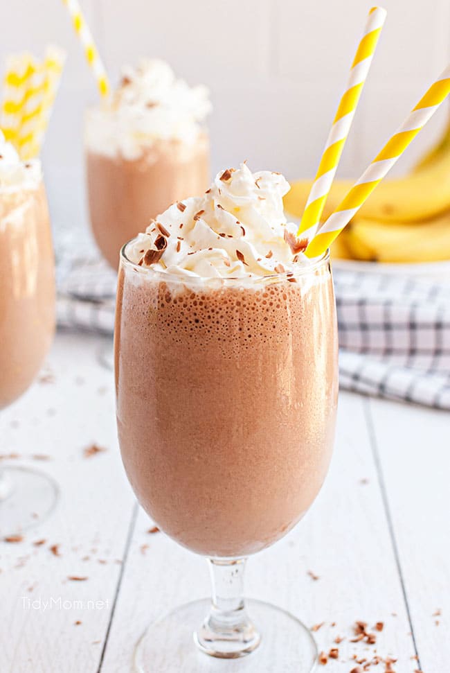 close up of milkshake with yellow straw