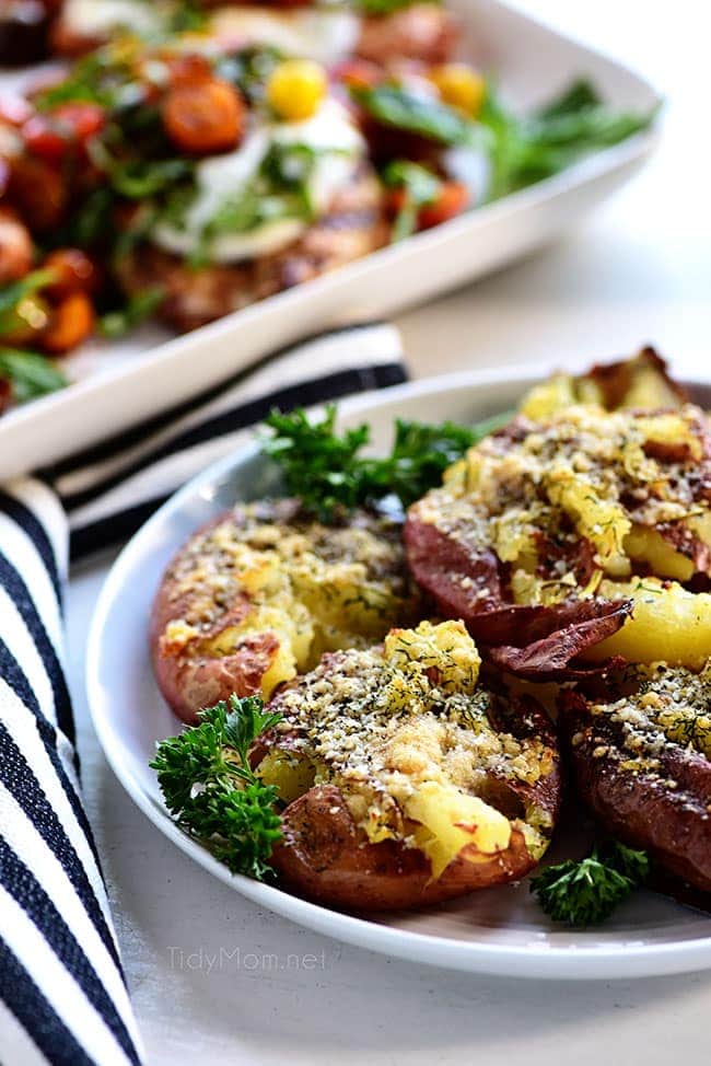 smashed potatoes on a plate with parsley garnish