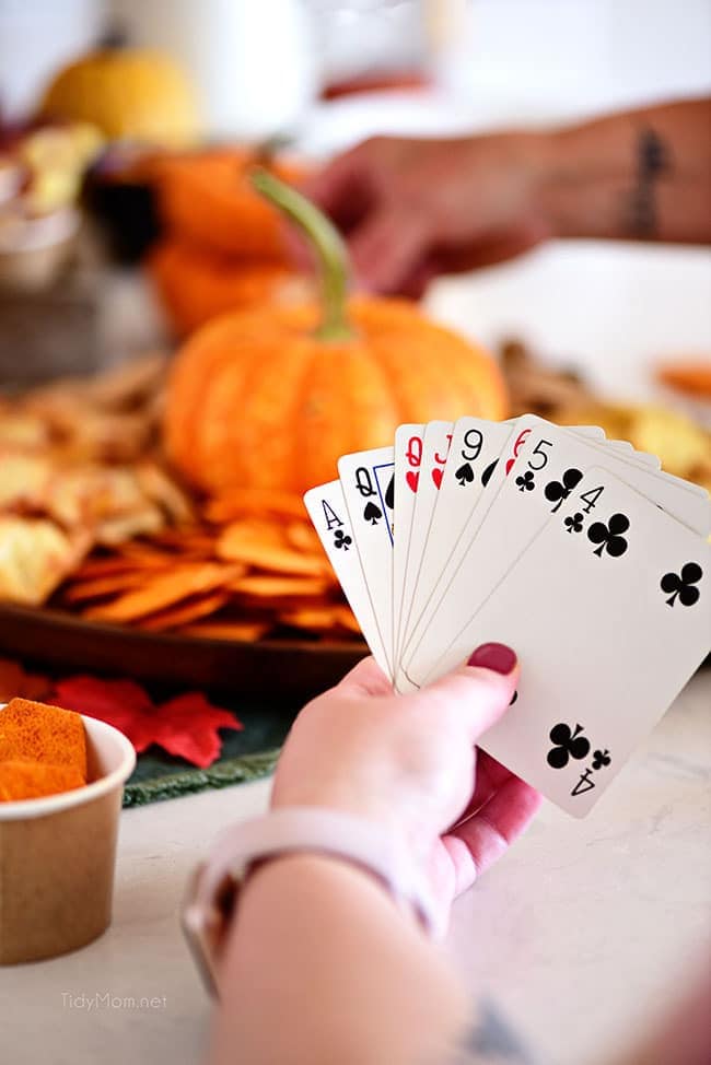 girl holding cards with snack tray in background