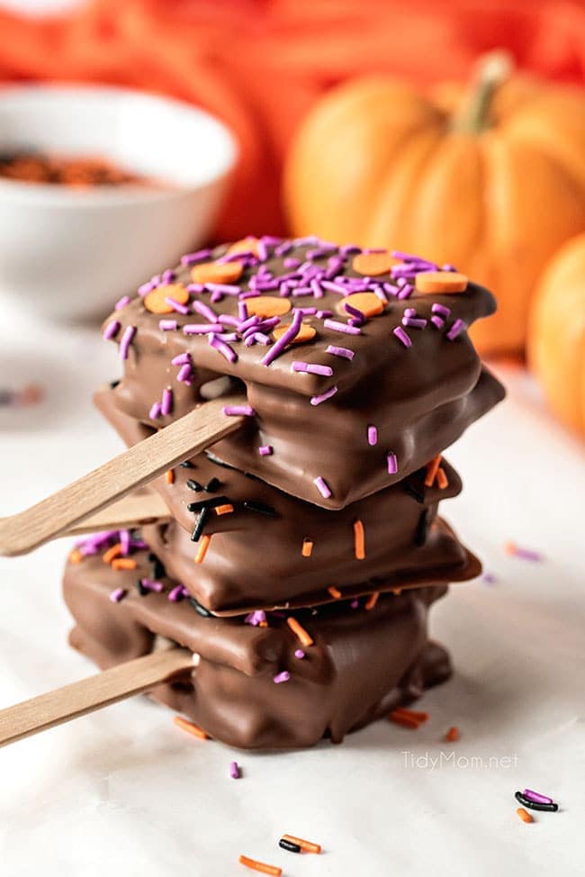 a stack of three s'mores pops with halloween sprinkles