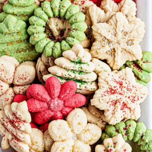 Christmas cookies made with a cookie press on a tray