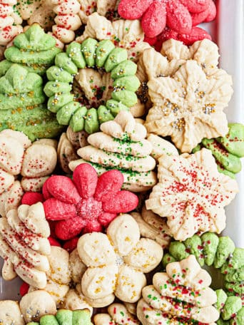 Christmas cookies made with a cookie press on a tray