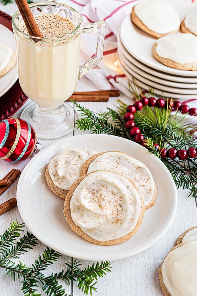 cookies on a plate with a mug of eggnog