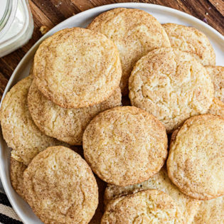 snickerdoodles piled on a white platter