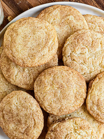 snickerdoodles piled on a white platter