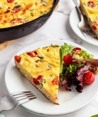 frittata serving on a plate with a salad