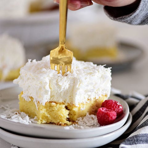 coconut cake with a gold fork poking into it