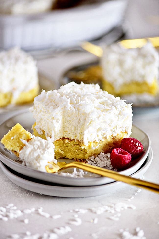 a bite of cake on a fork next to a slice of cake