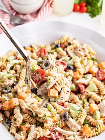 big bowl of pasta salad with a serving spoon