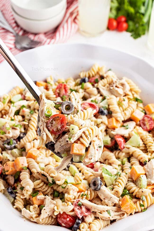 big bowl of pasta salad with a serving spoon