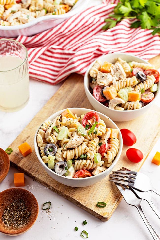 two bowls of pasta salad with tomatoes