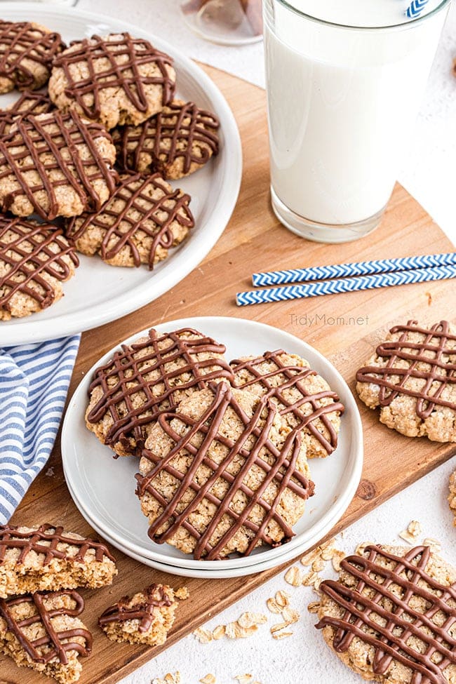 overhead shot of oatmeal cookies with chocolate drizzle on a plate