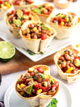texas caviar in baked tortilla cups on a plate