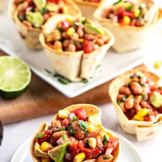 texas caviar in baked tortilla cups on a plate