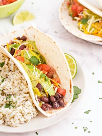 fresh avocado taco on a plate with a side of lime rice