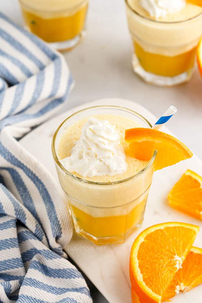 a glass fill with an Orange Julius and topped with fresh orange slices