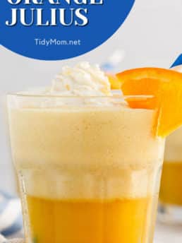 a glass with an orange julius on a counter