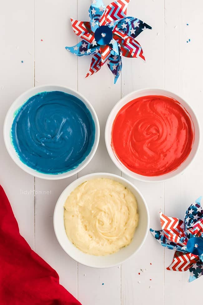 3 bowls with red, white and blue cake batter
