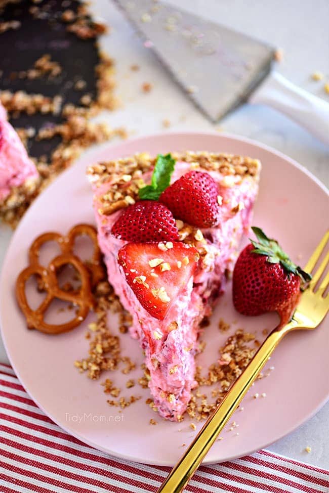 a slice of strawberry pretzel pie on a pink plate
