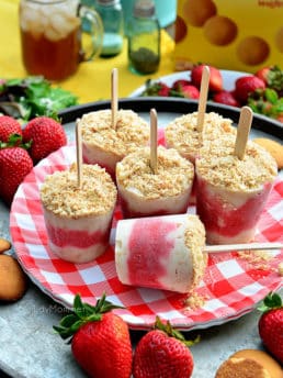 strawberry shortcake popsicles on a red gingham plate