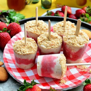 strawberry shortcake popsicles on a red gingham plate