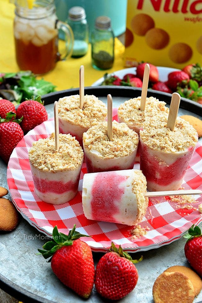 strawberry shortcake popsicles on a red gingham plate