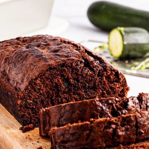 sliced loaf of chocolate zucchini bread on a cutting board