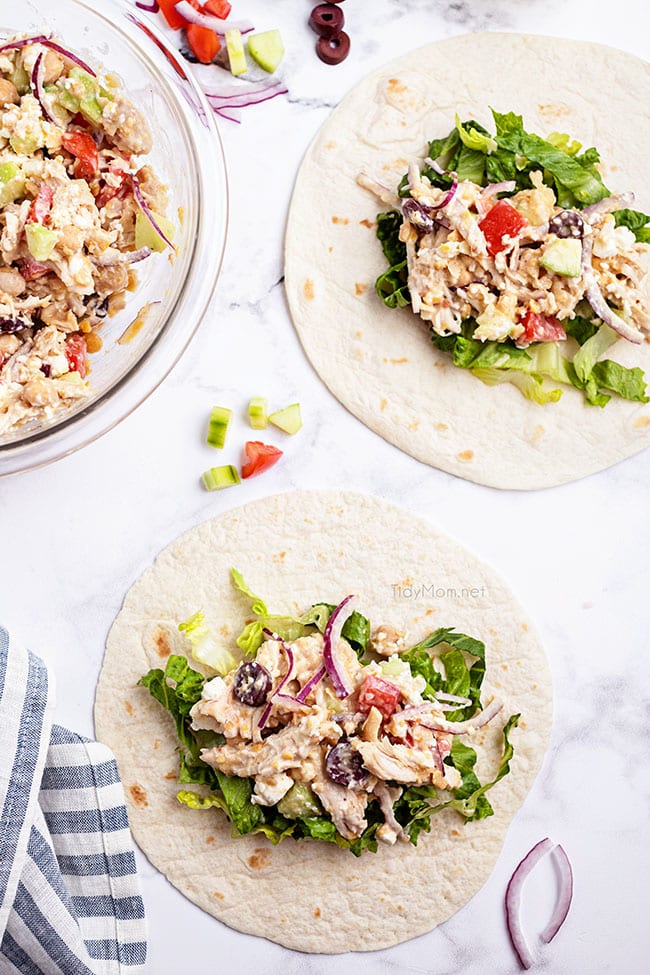 flour tortillas on a counter with greek chicken filling