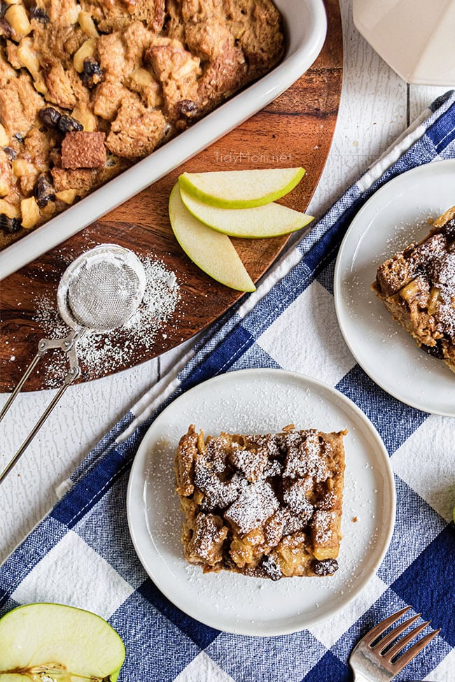 apple bread pudding with a dusting of powdered sugar on a plate