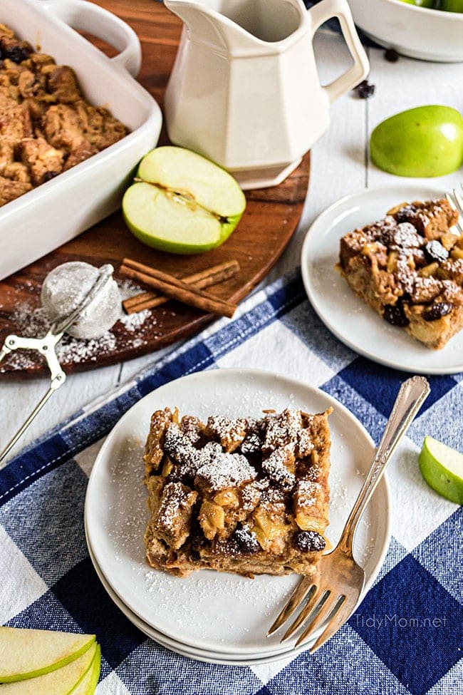 apple bread pudding with a sprinkle of powdered sugar on plates 