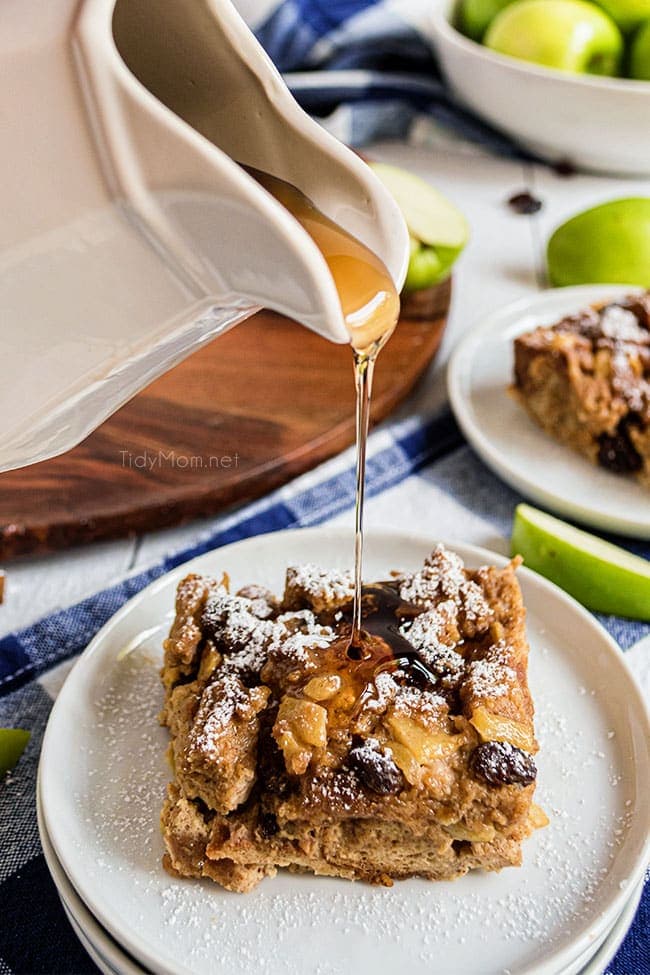 pouring syrup on a serving of bread pudding