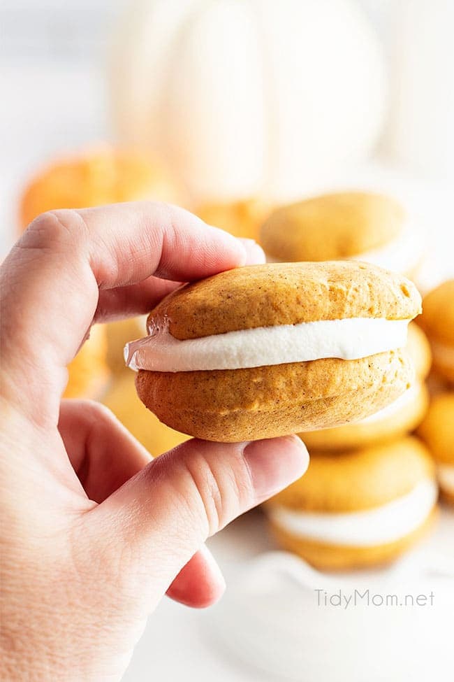 woman's hand holding a pumpkin whoopie pie